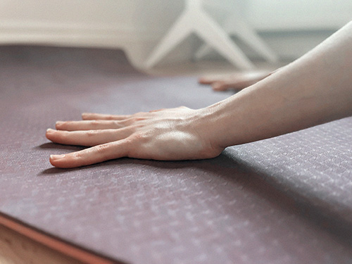 Palm is flat on the ground. Weight is not spread through the fingers. Wrong Hands on yoga mat in incorrect position.