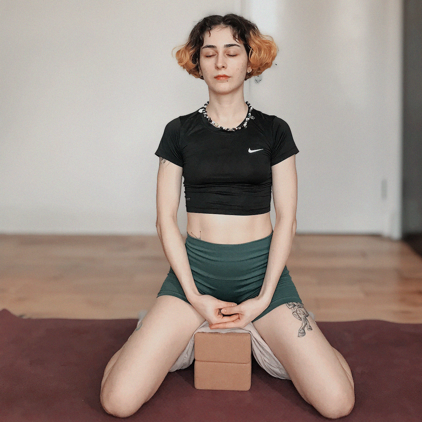 Person sitting and meditating on the floor